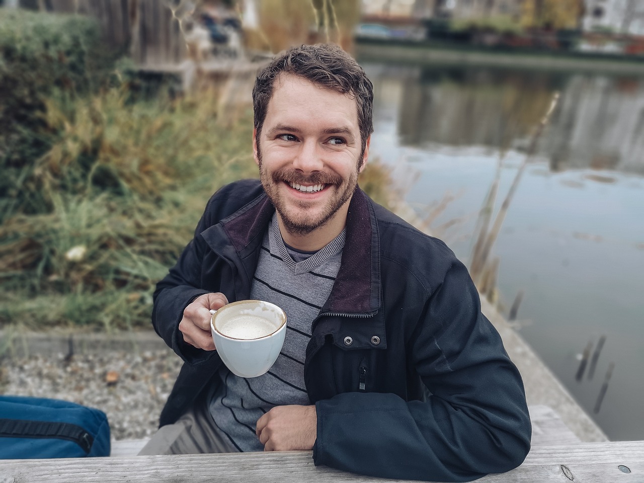 Smiling scientist with cup of coffee.