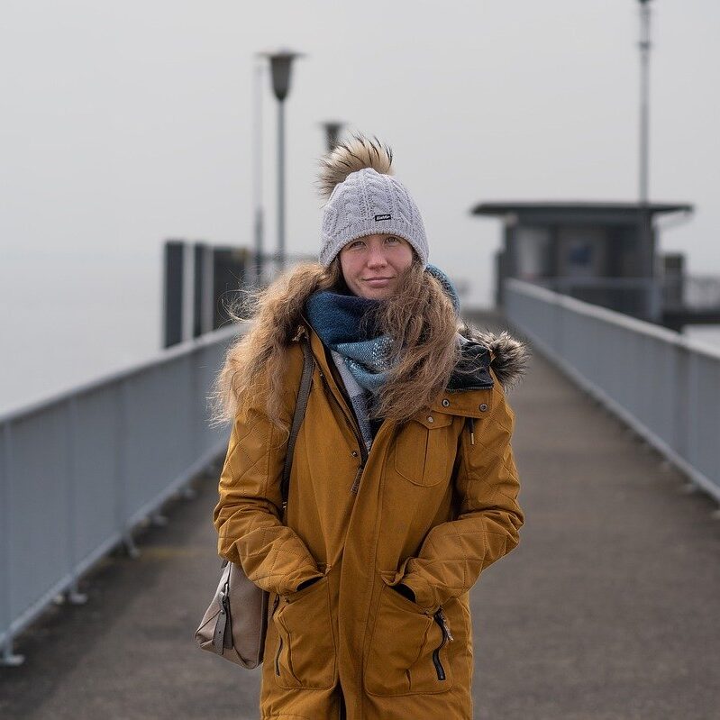 Woman scientist, beanie, pier